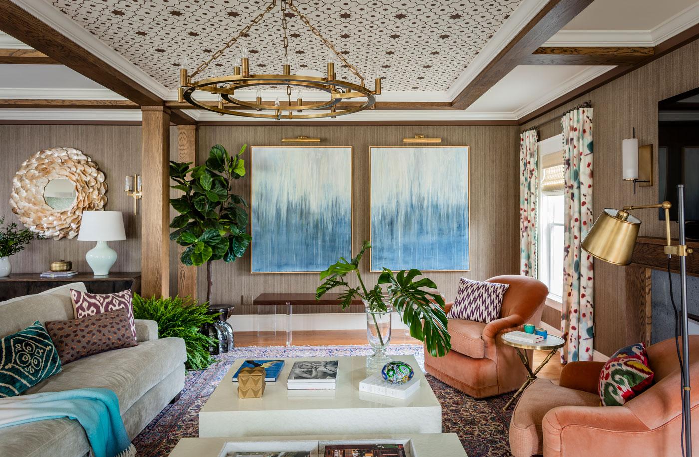 Redesigned Family room with custom ceiling blue abstract paintings on the wall and coral chairs